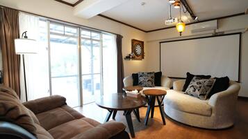 120-inch flat-screen TV with cable channels, video-game console, Netflix