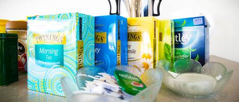 A variety of tea products and a teapot on a table.