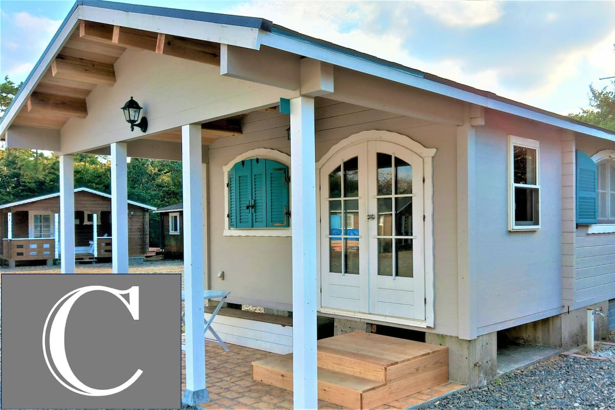 A single-story house with a porch, a front door with glass panels, and a small front yard.