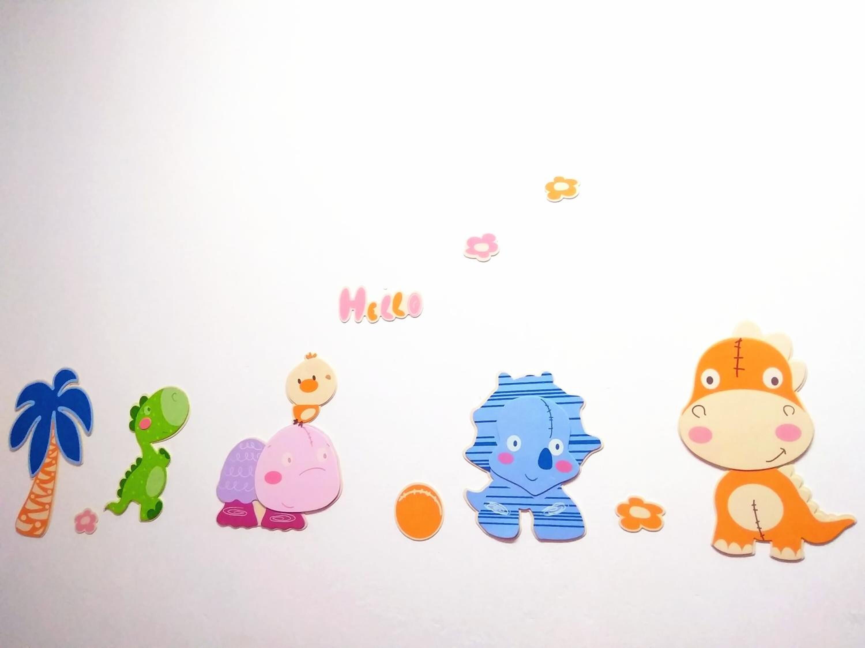 A series of cut-out animal figures arranged in a row on a white background.