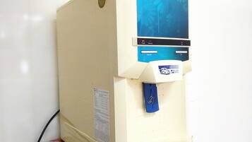 A water dispenser with a blue top labeled "BIO PURE" and a white base.