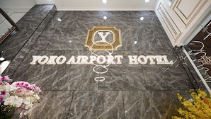A marble floor with the logo and name of the Yoko Airport Hotel. - Yoko Airport Saigon Hotel (Ho Chi Minh City)