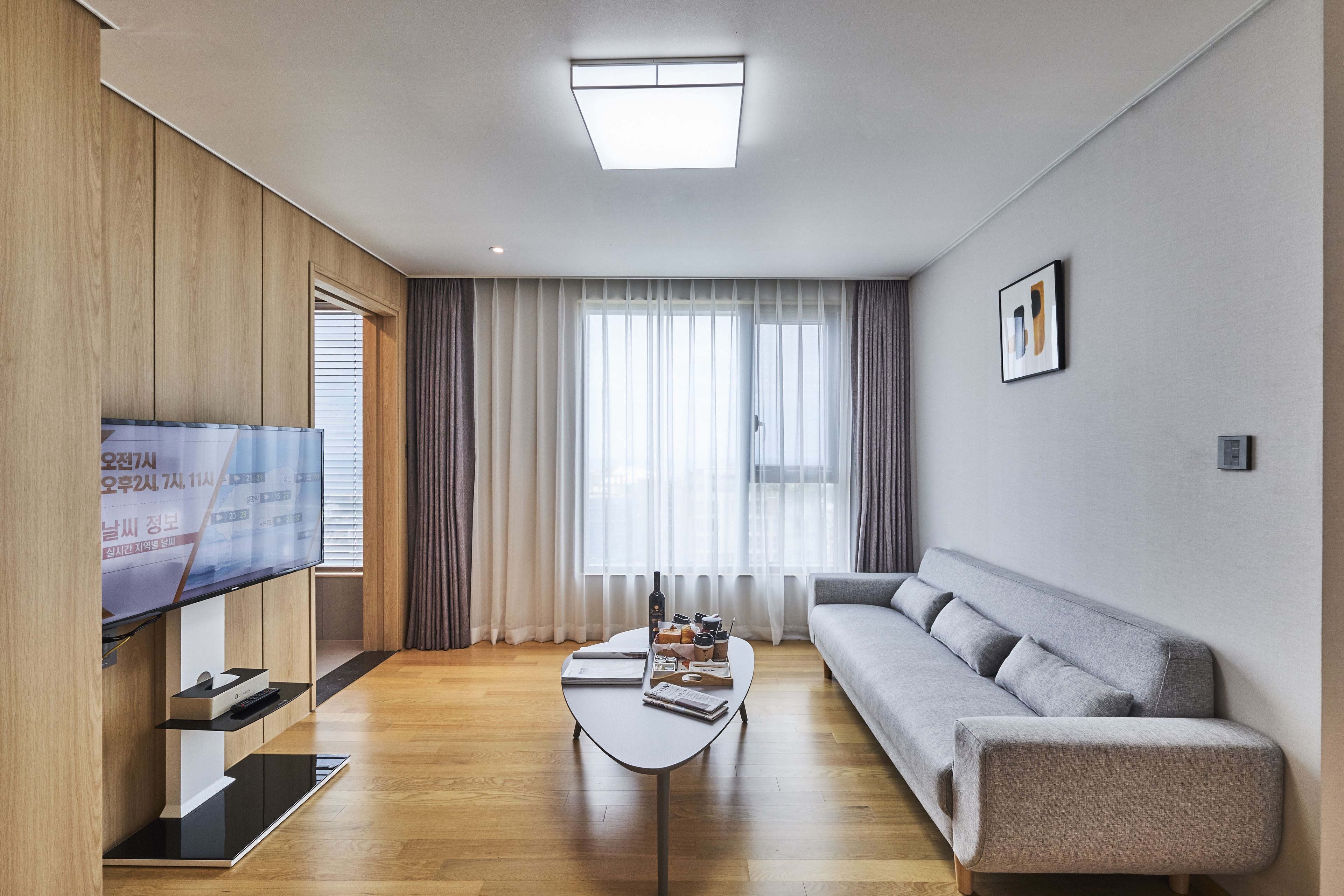 Suite (with Microwave and Washing Machine) | Living area | 42-inch flat-screen TV with cable channels, TV