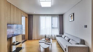 Suite (with Microwave and Washing Machine) | Living area | 42-inch flat-screen TV with cable channels, TV