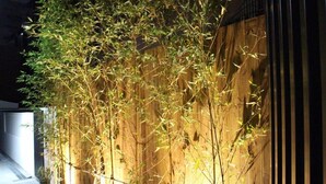 A bamboo fence with a wooden wall behind it. - The Stay Simple (Seoul)