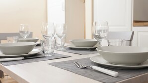 A dining table set with white plates, bowls, glasses, and cutlery. - Italianway   - Lazzaro Palazzi (Milan)