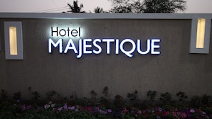 A wall with the sign "Hotel MAJESTIQUE" illuminated in blue. - Hotel Majestique pune (Pune)