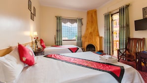A hotel room with two beds, a fireplace, a television, and a view of the outside. - SapaAubergeDangtrung Hotel (Sa Pa)