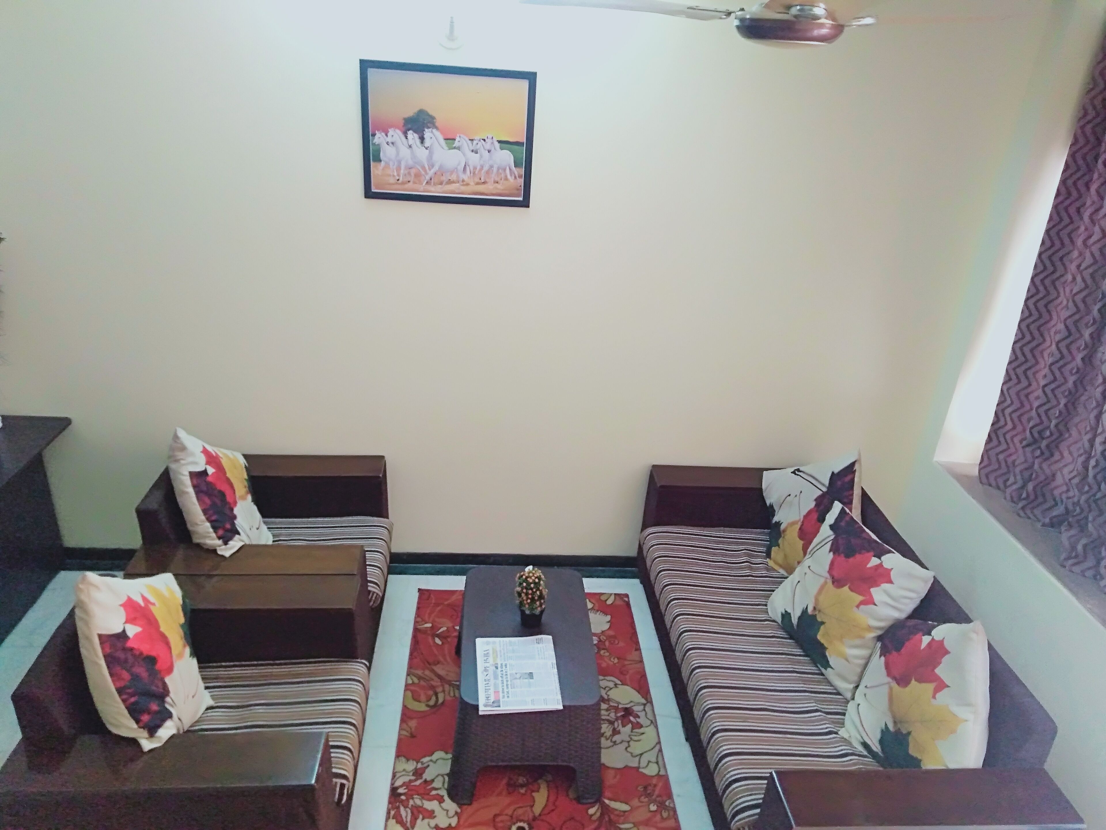 A living room with two sofas, a coffee table, and a wall-mounted picture.