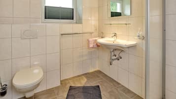 Separate bathtub and shower, towels