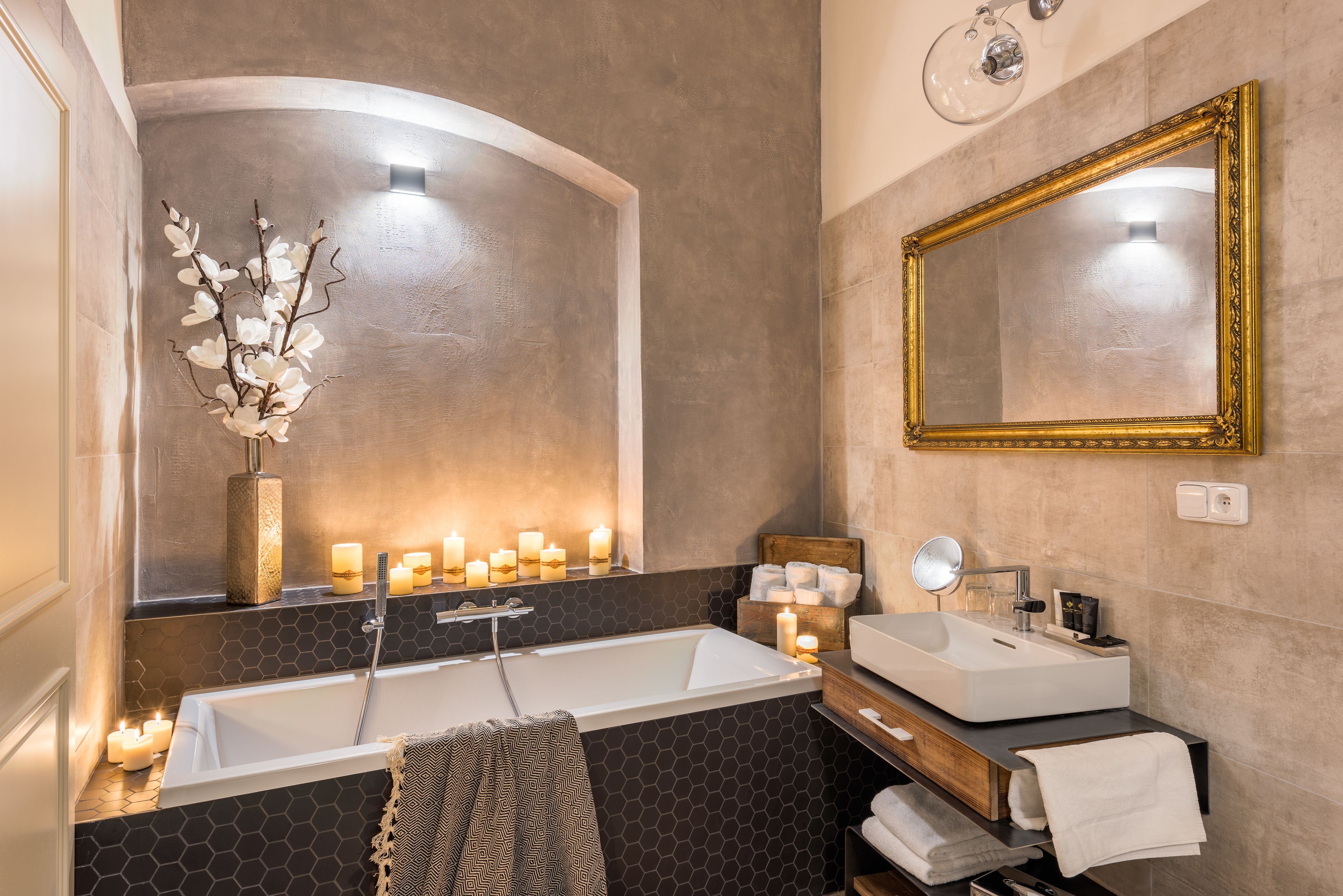 A modern bathroom with a freestanding bathtub, a vanity with a sink, and a large mirror.