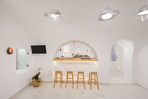 Luxury Villa, 2 Bedrooms, Private Pool, Sea View | Living area | 50-inch flat-screen TV with satellite channels, TV, fireplace - Hyperion Oia Suites (Santorini)