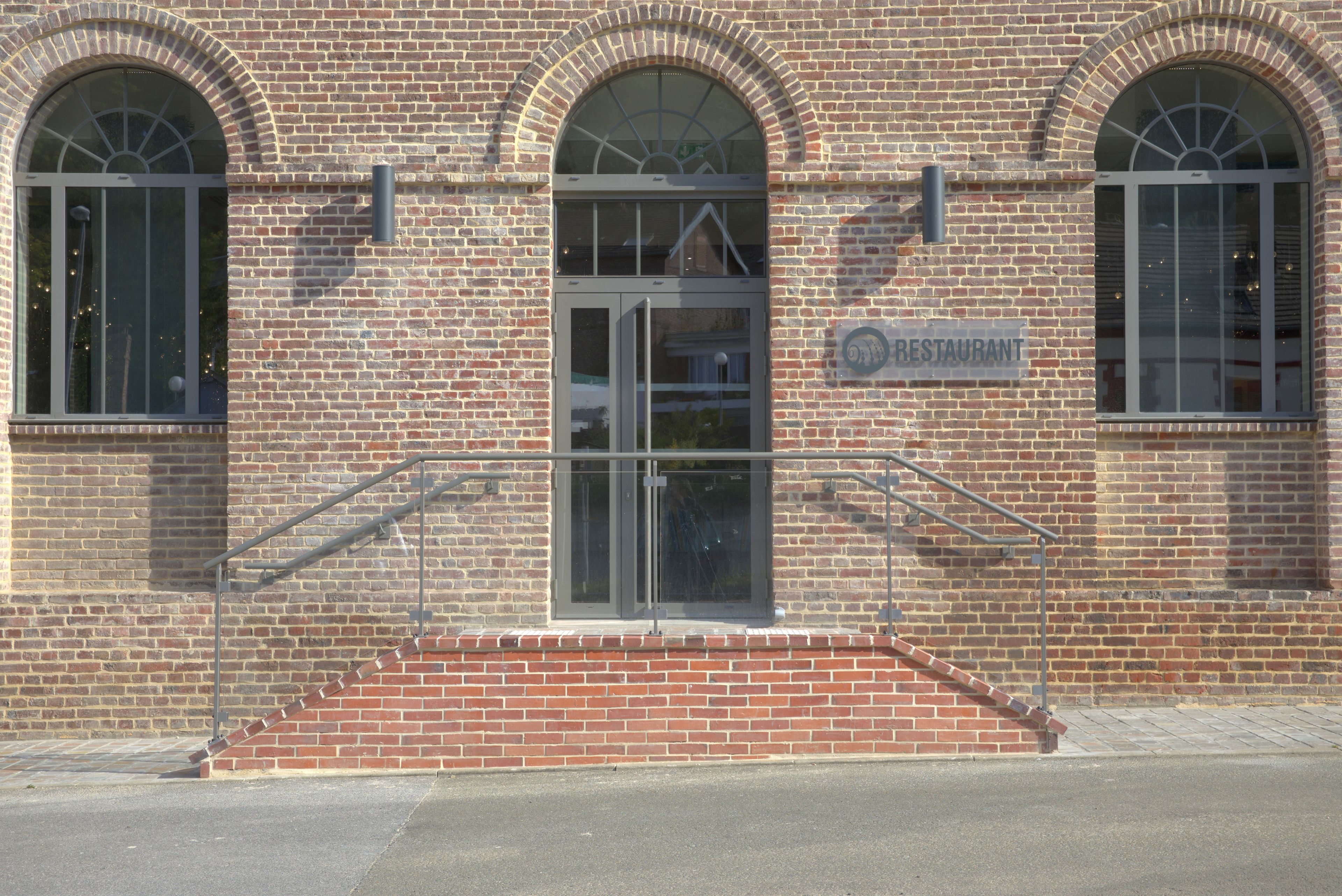 A brick building with a sign reading "RESTAURANT" above the entrance.