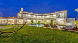 A large, modern house with a swimming pool and outdoor seating area. - Levin Otel (Cesme)