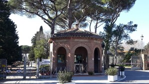 A small brick pavilion with arched doorways, surrounded by trees and a paved area. - Private flat in Rome Ostia Antica (Ostia Antica, Roma)