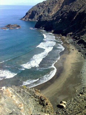 A coastal landscape with a rocky shoreline and clear blue water. - small house but a great atmosphere outside (Tamargada)