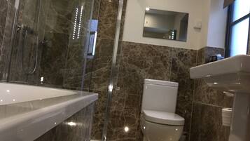 Bathtub, hair dryer, towels, soap