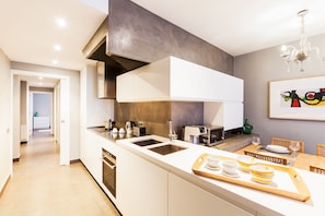 Enjoy cooking in this well-lit kitchen with an oven, stainless steel sink, and dining area.
