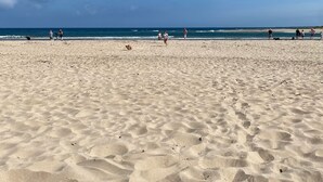 A sandy beach with footprints and a pair of shoes in the foreground. - Fossil Bank, a luxury detached retreat in the heart of Alnmouth, with parking (Alnmouth)