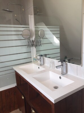Een bad/douchecombinatie, een haardroger, een bidet, handdoeken