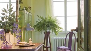 A room with a wooden desk, a chair, a radiator, and a window with curtains. - Picturesque apartment in a medieval village perched at top a mountain ridge (Imperia)