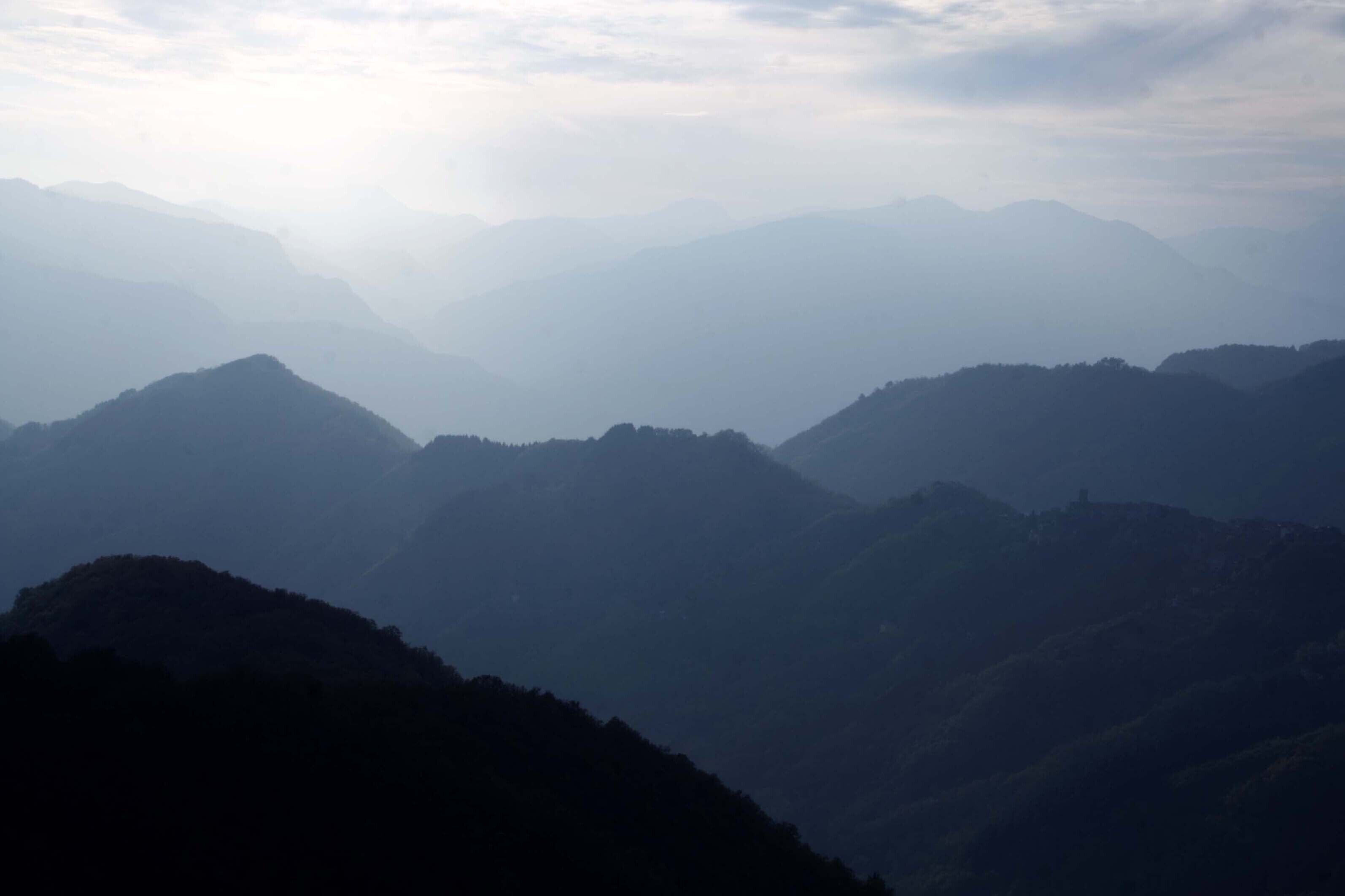A mountainous landscape with multiple peaks and valleys.