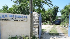 A sign for 'LES MESANGES' indicating a hotel with a room and dining area.