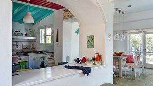 A kitchen with a stone floor, a white countertop, and a red and blue ceiling. - Beatifull seaview / 100m from beach (Amaliapolis)