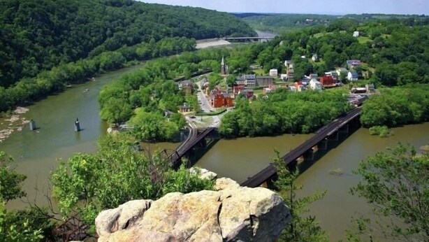 A riverside town with a prominent bridge, lush greenery, and a mix of residential and commercial buildings. - Blue Ridge Beauty Home Dog Friendly, Walk to Rivers, A.T. Trail, & HF. NEW LVP (Bolivar)