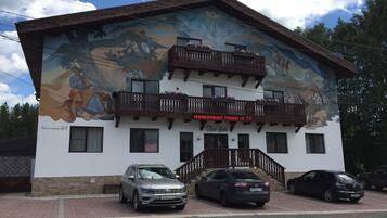 Traditional building with a unique mural and wooden balconies, offering a glimpse into the local culture.