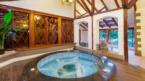 A spa area with a hot tub, wooden beams, and a view of the outdoors. - Hotel Rincon de Puembo, BW Signature Collection (Puembo)
