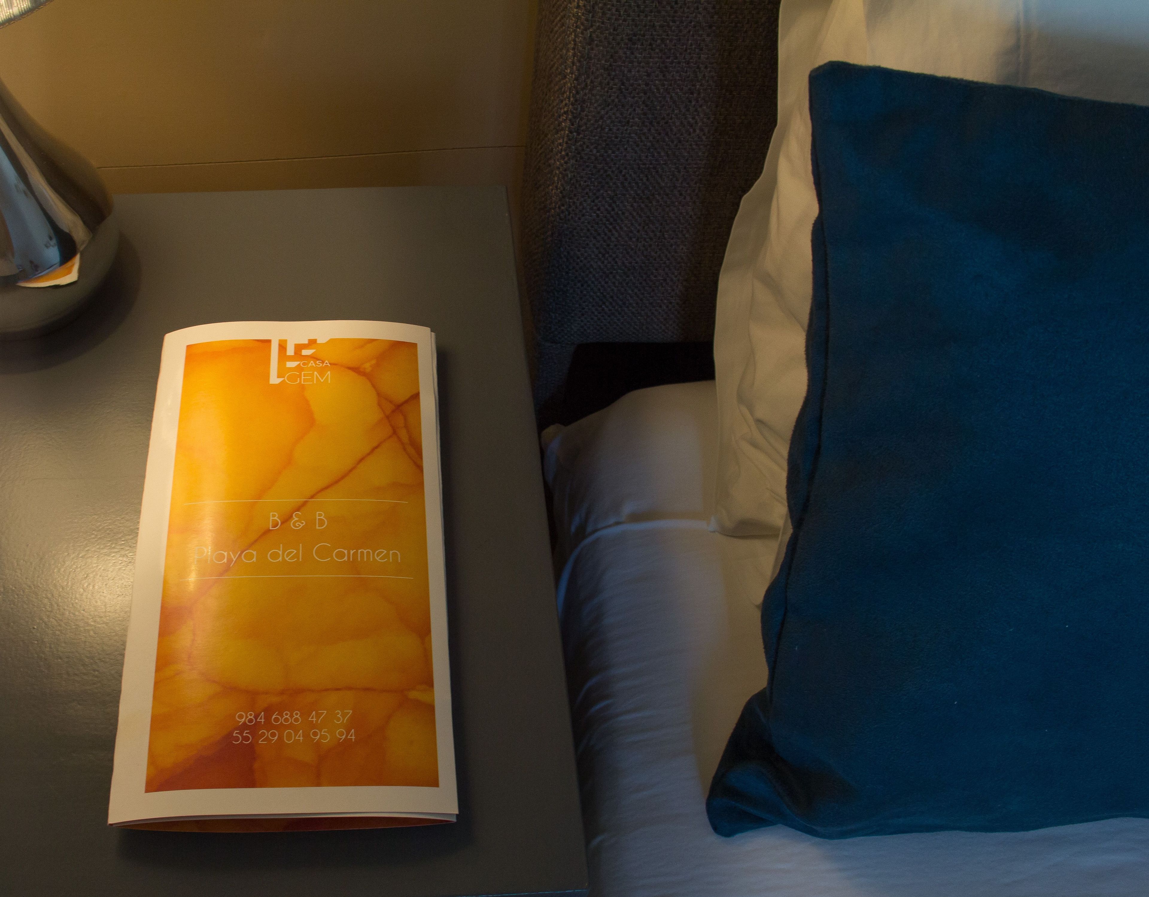 A brochure for Casa Lem B&B Playa del Carmen with contact numbers.