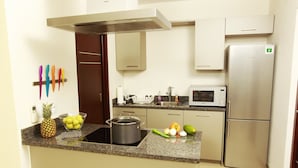 Apartment, 1 Bedroom, Pool Access, Partial Ocean View | Private kitchen | Coffee/tea maker, full-size fridge, microwave, oven - Green View at Blue Bay Curacao (Sint Michiel)