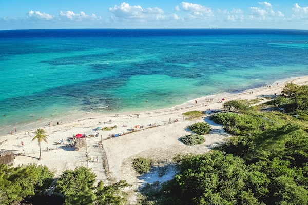Playa en los alrededores, playa de arena blanca y toallas de playa
