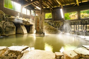 A hot spring area with stone walls and a wooden ceiling. - Kinosato Yamanoyu (Kokonoe)