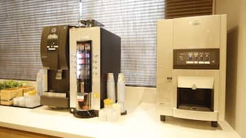 A coffee station with an ice dispenser, a coffee machine, and a water dispenser.
