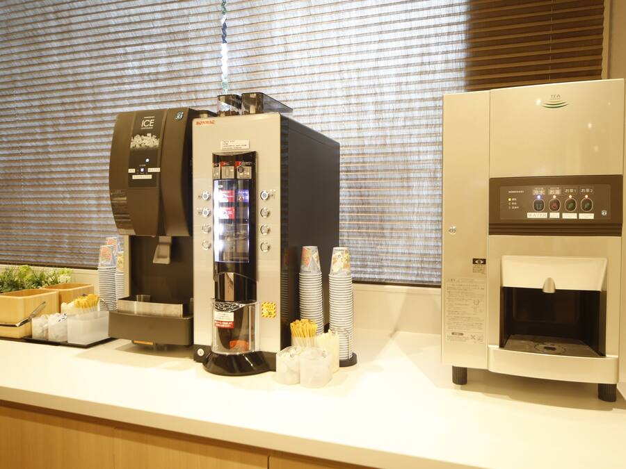 A coffee station with an ice dispenser, a coffee machine, and a water dispenser.