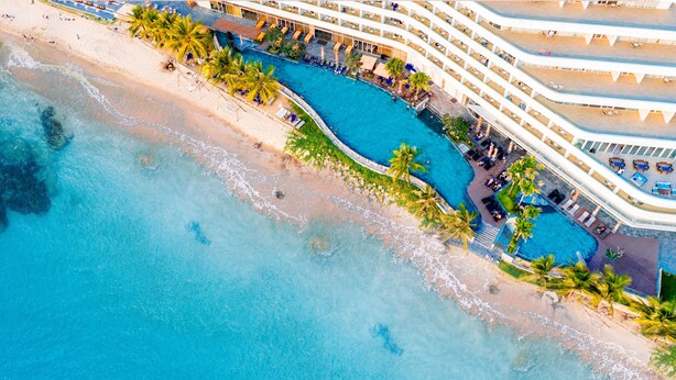 An aerial view of a resort with a large swimming pool, beach, and multiple balconies. - Seashells Hotel and Spa Phu Quoc (Phu Quoc)