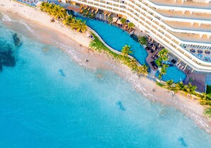An aerial view of a resort with a large swimming pool, beach, and multiple balconies. - Seashells Hotel and Spa Phu Quoc (Phu Quoc)