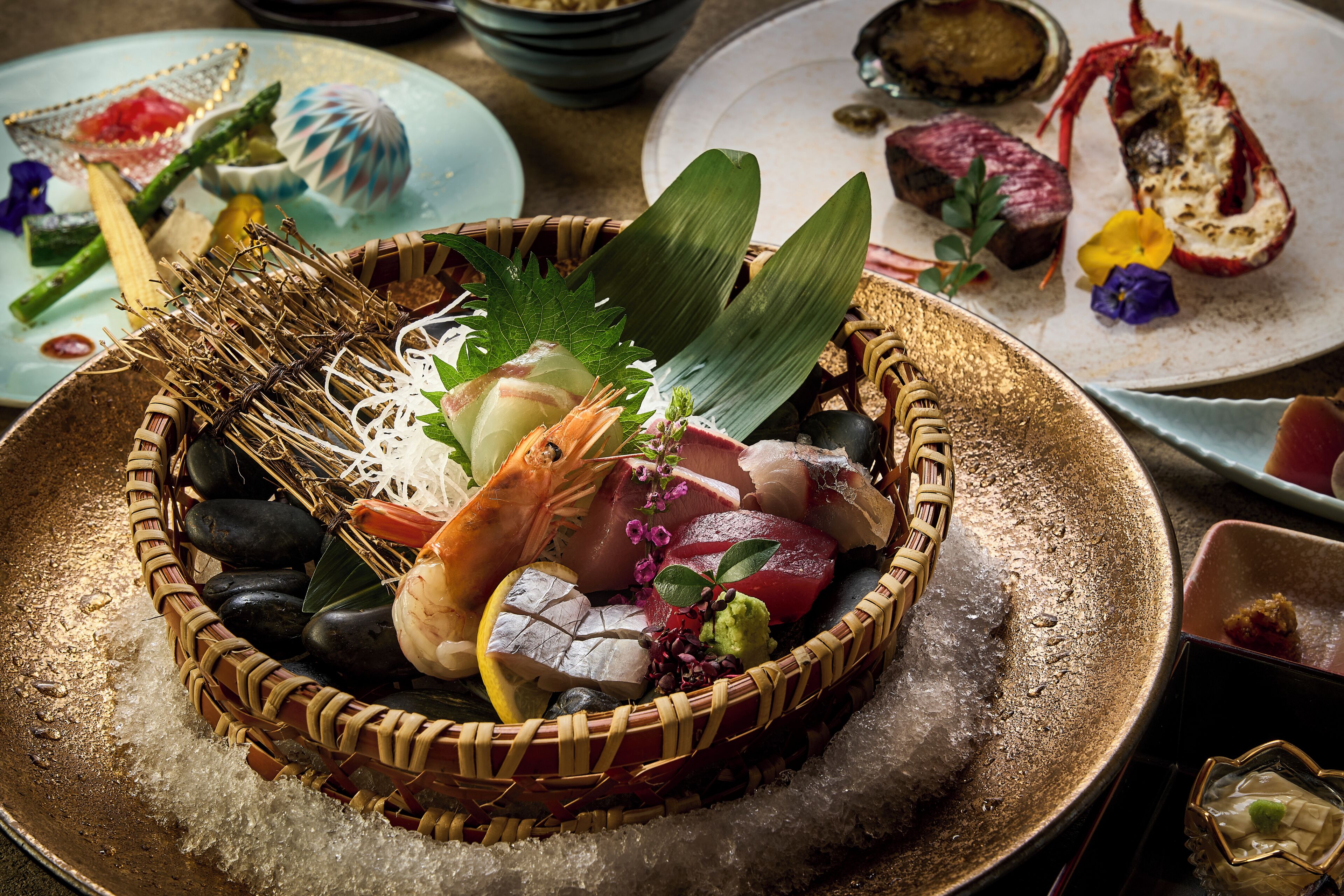 A sushi platter with various seafood and garnishes.