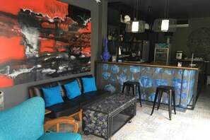 A modern bar area with stools, a counter, and a large abstract painting on the wall. - Seava House Ao-Nang Krabi (Krabi)