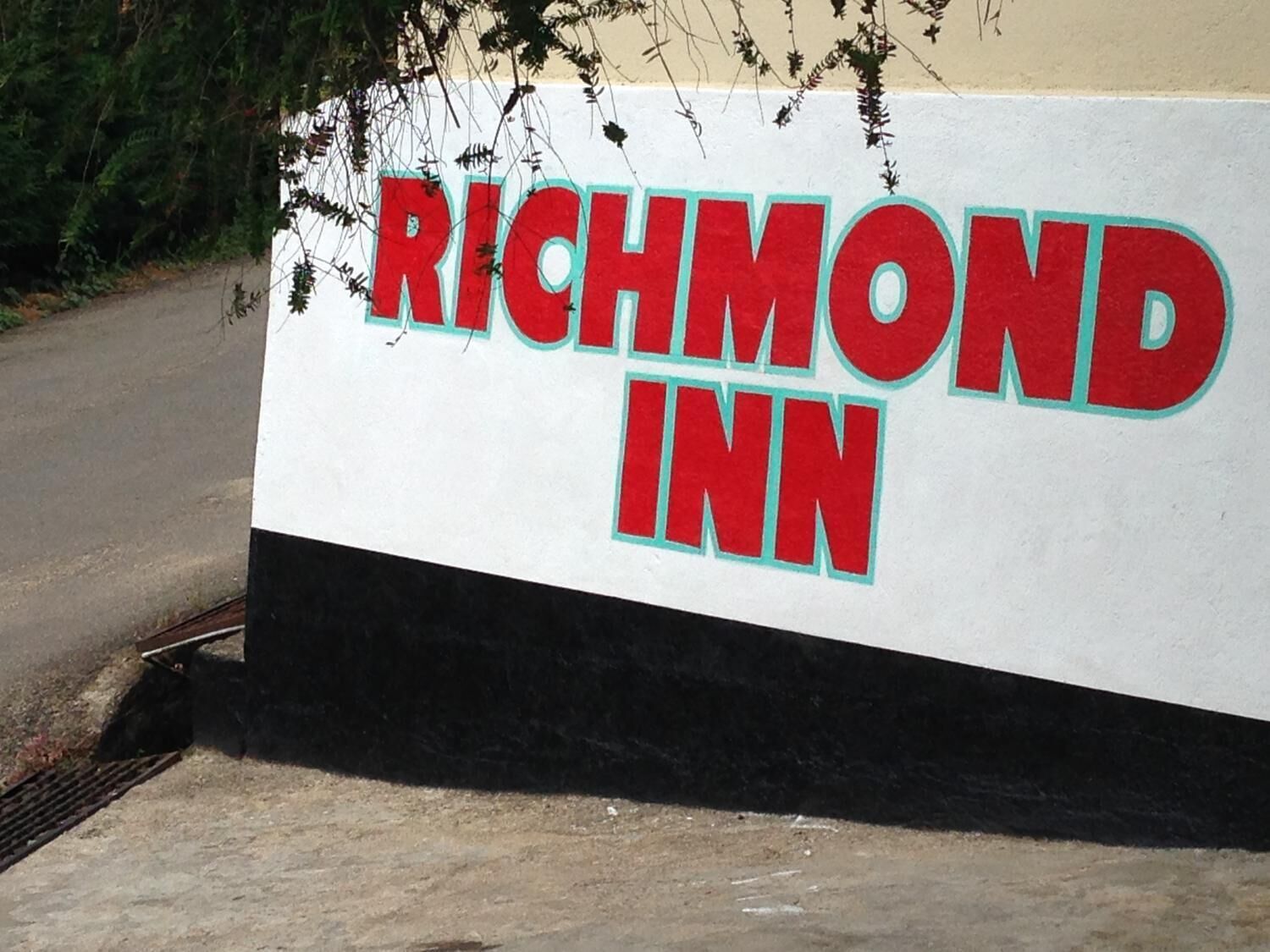 A sign for Richmond Inn with bold red lettering on a white background.