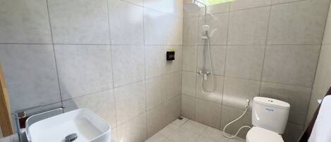 A modern bathroom with a bathtub, toilet, and sink.