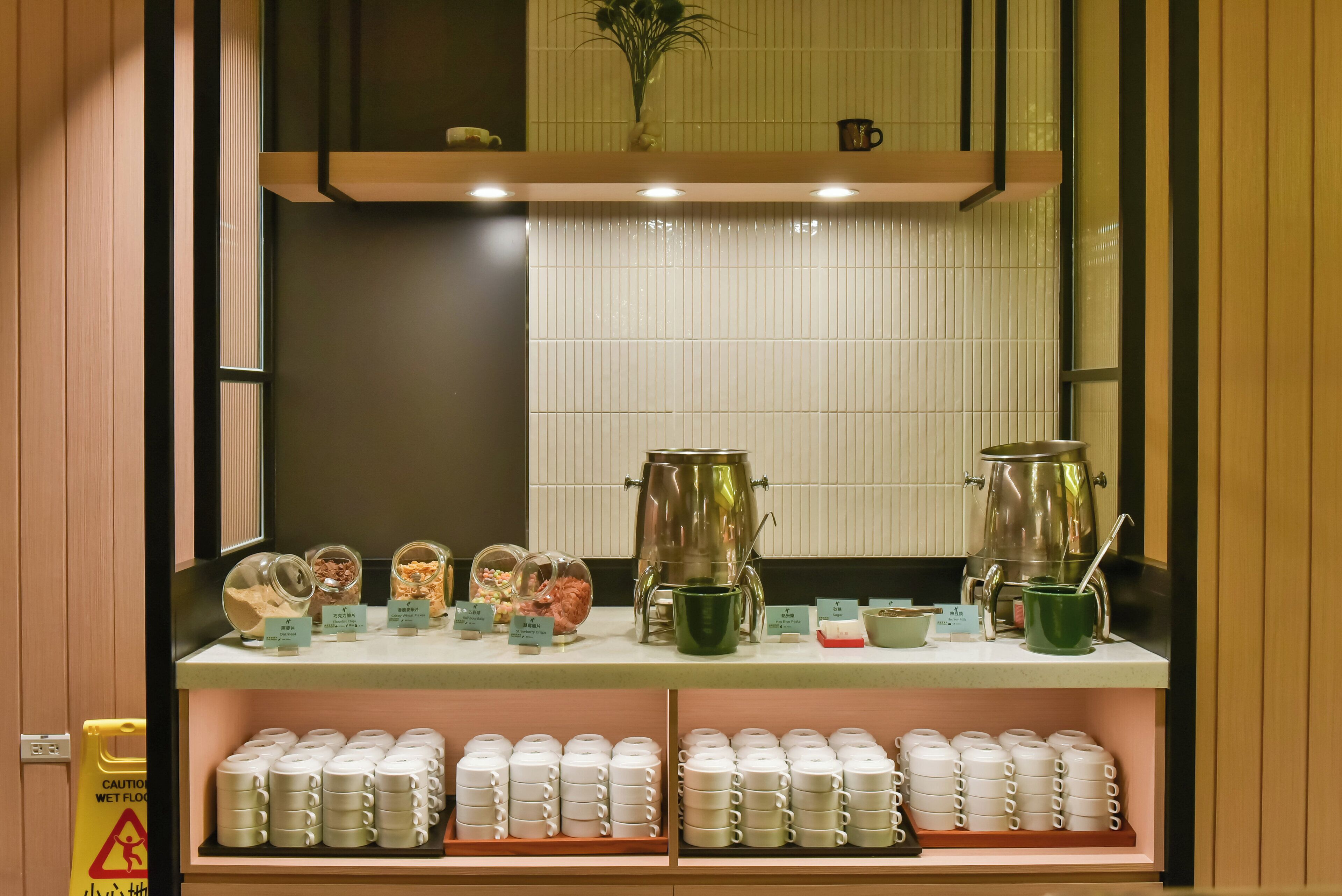 A display of tea sets and coffee pots in a restaurant setting.