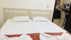 A hotel room with a bed, two pillows, and a red blanket. - Fimaj Residence & Apart Hotel (Kayseri)