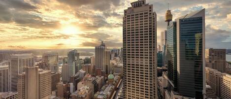 A cityscape with modern skyscrapers, a prominent tower, and a historic building with a dome.