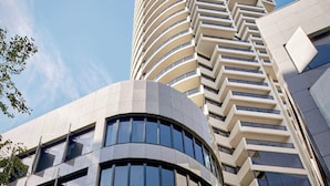 A modern hotel with a curved facade, named 'Meriton Kent Street Suites.' - Meriton Suites Kent Street, Sydney (Sydney)