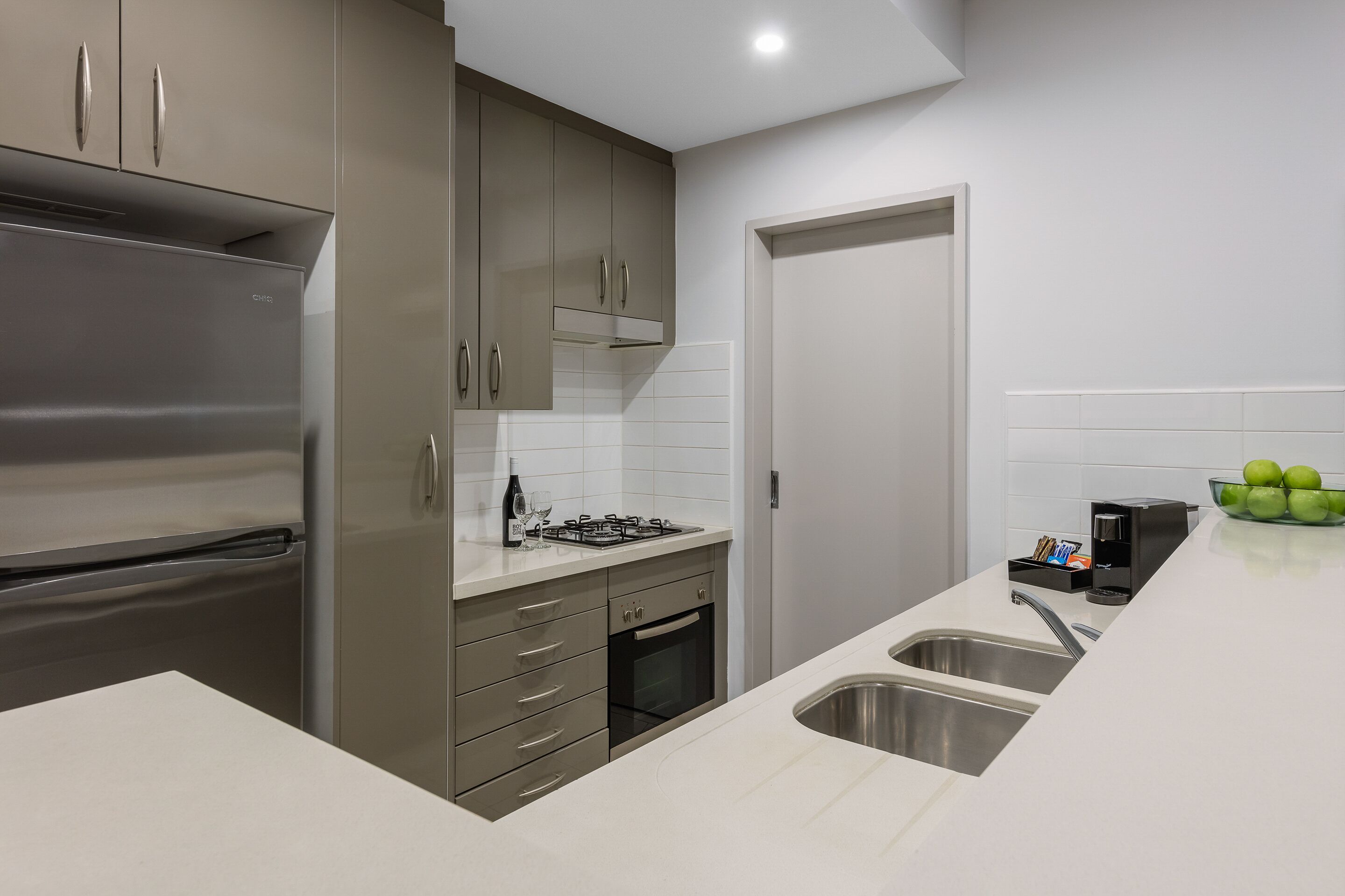 A modern kitchen with stainless steel appliances, a gas stove, and a sink.