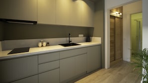 Una cocina moderna con un lavamanos integrado, armarios y una encimera.