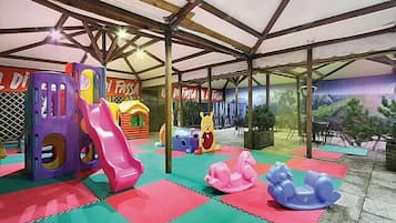 Kids can play and climb in the indoor play area with a slide and ball pit.